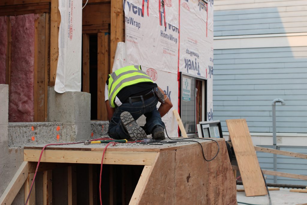 A worker finishing a staircase in the Hayden courtyard.